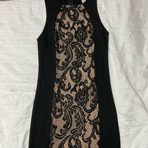 Never worn black Fitted Dress with Lace detailing through the center. Size small